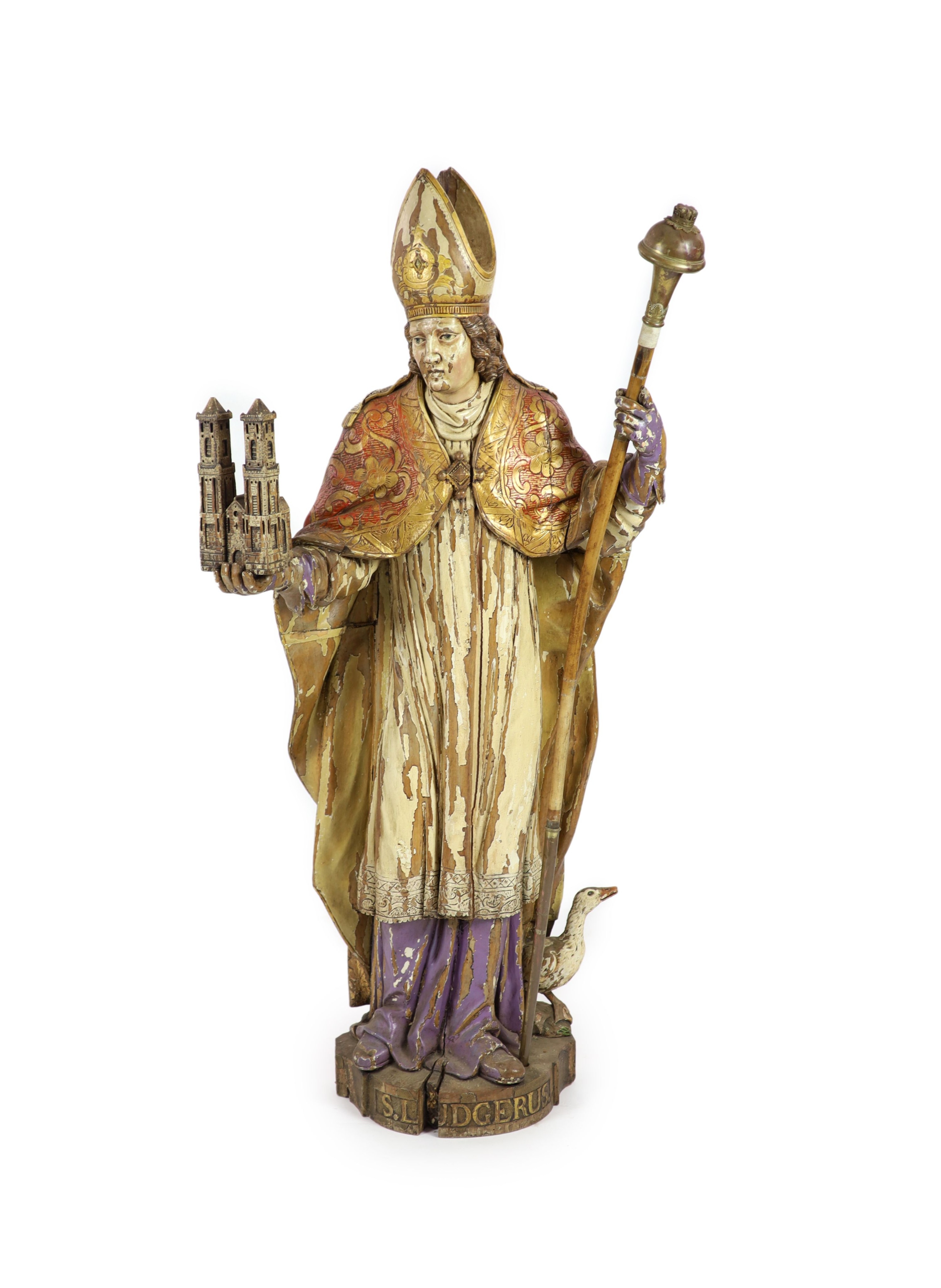 A 19th century German painted carved wood figure of St Ludgerus (b.742) H 157cm.